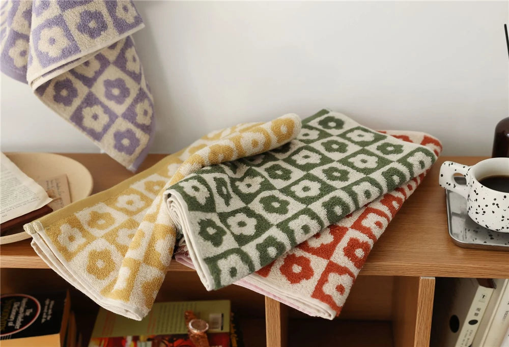 Orion Towel: Retro-inspired hand and bath towels with 70's floral print, soft cotton, various colorways. Shop now.