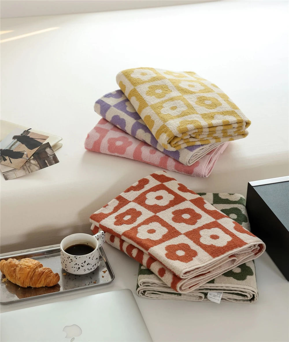 Orion Towel: Retro-inspired hand and bath towels with 70's floral print, soft cotton, various colorways. Shop now.
