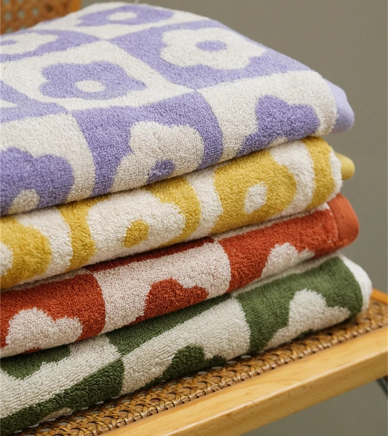 Orion Towel: Retro-inspired hand and bath towels with 70's floral print, soft cotton, various colorways. Shop now.