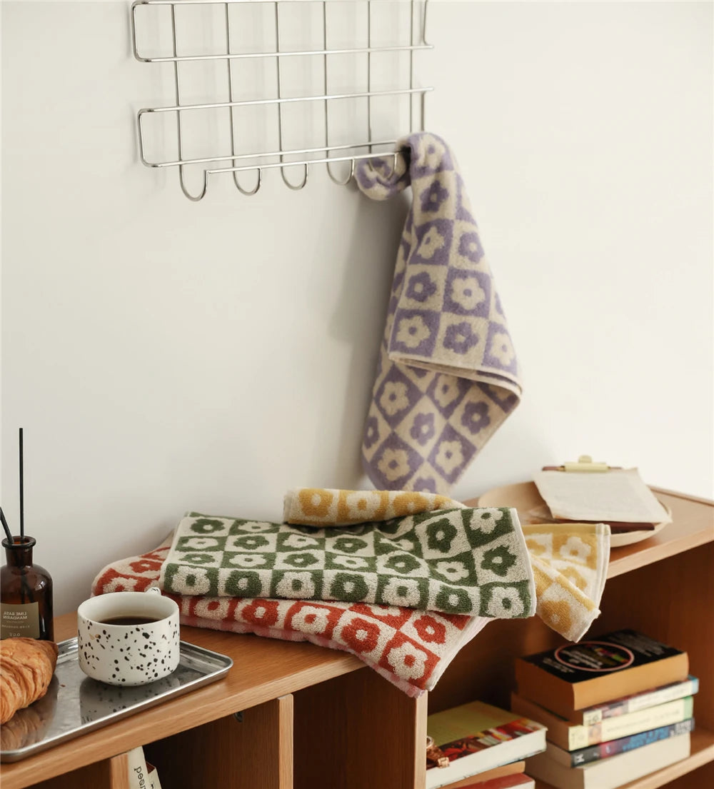 Orion Towel: Retro-inspired hand and bath towels with 70's floral print, soft cotton, various colorways. Shop now.