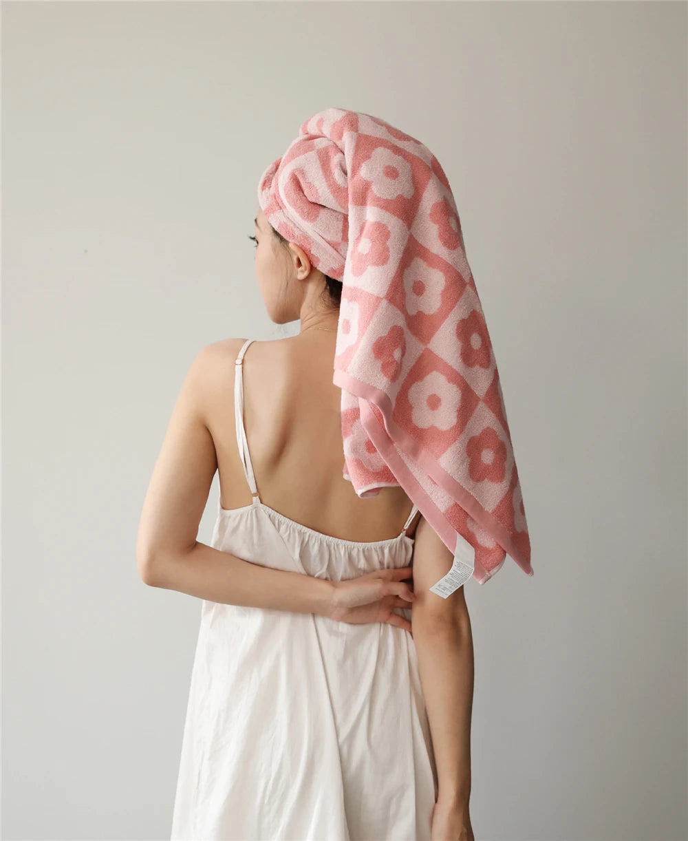 Orion Towel: Retro-inspired hand and bath towels with 70's floral print, soft cotton, various colorways. Shop now.