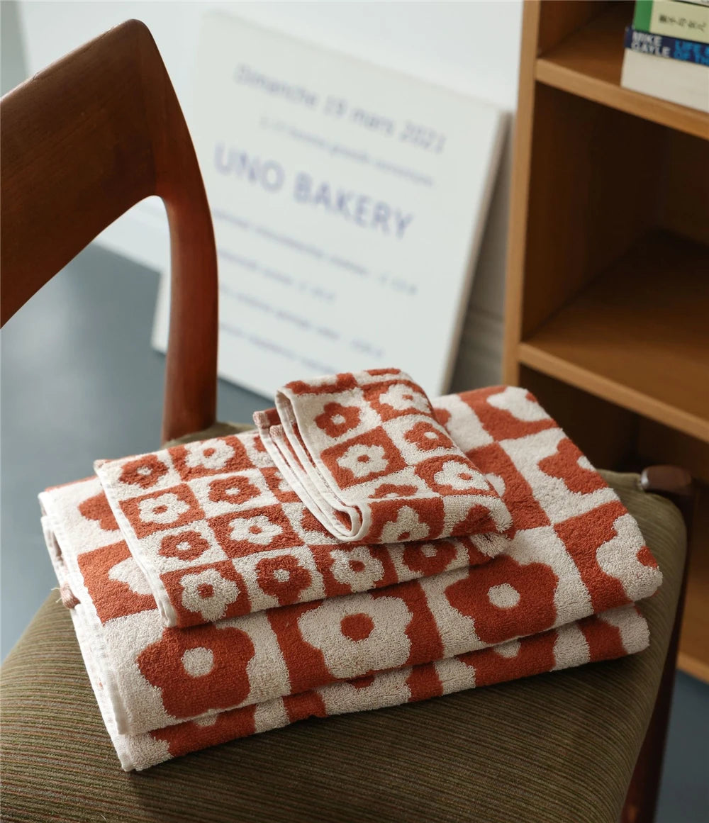 Orion Towel: Retro-inspired hand and bath towels with 70's floral print, soft cotton, various colorways. Shop now.