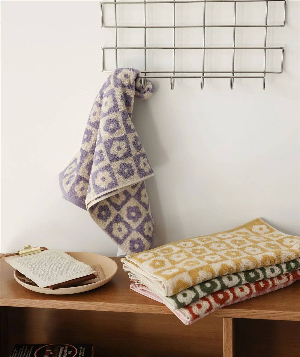 Orion Towel: Retro-inspired hand and bath towels with 70's floral print, soft cotton, various colorways. Shop now.