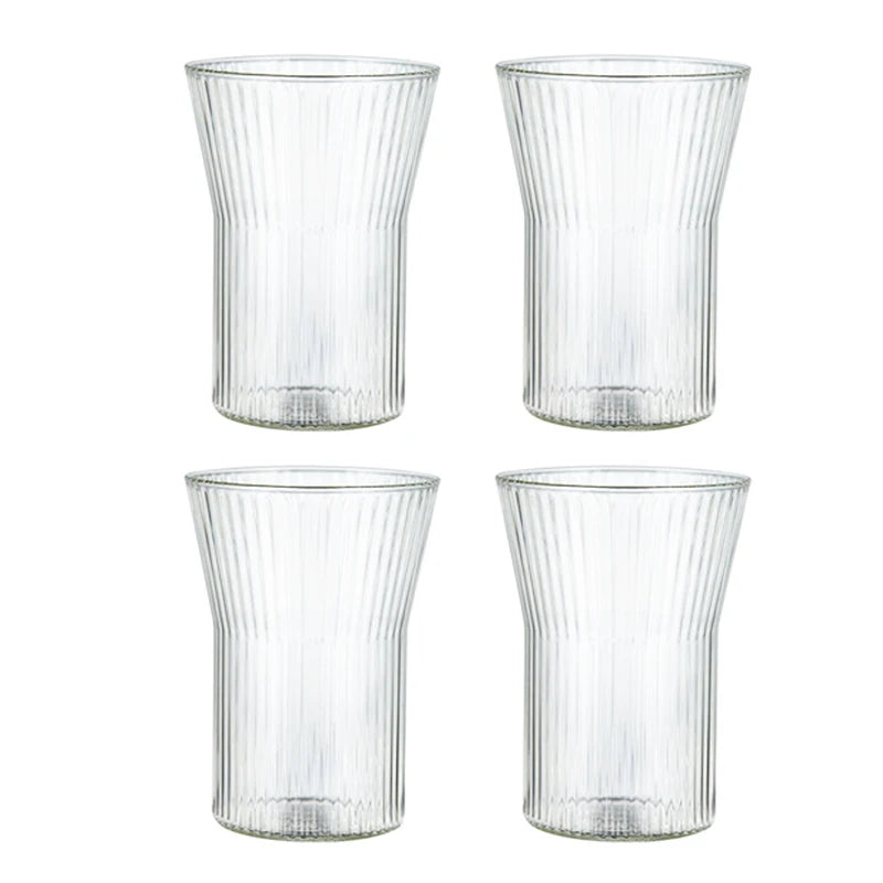 Solange Tumbler Set – set of four rippled glass tumblers in two sizes and shapes, perfect for whiskey, juice, or water, combining modern elegance with everyday functionality.