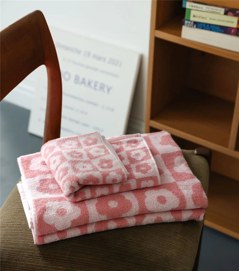 Orion Towel: Retro-inspired hand and bath towels with 70's floral print, soft cotton, various colorways. Shop now.