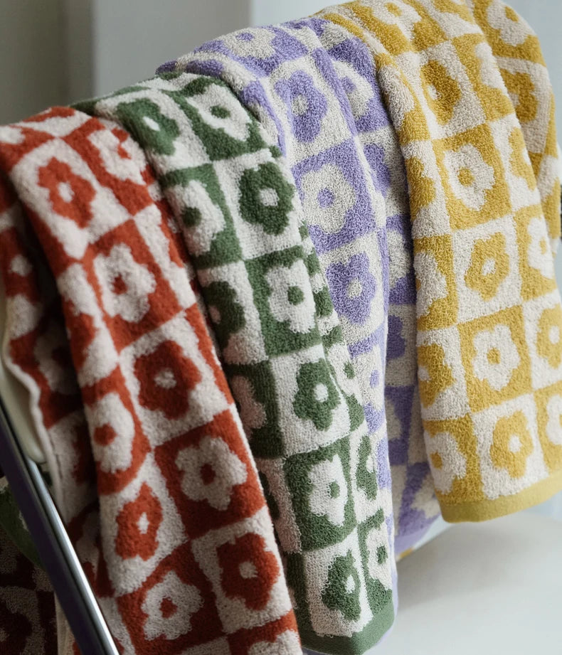 Orion Towel: Retro-inspired hand and bath towels with 70's floral print, soft cotton, various colorways. Shop now.