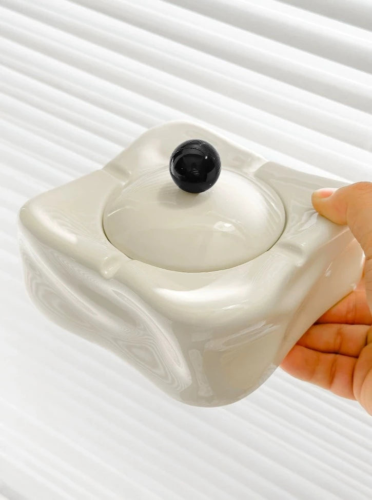 Foresta Ceramic Ashtray with cute ball detail, irregular shape, and modern design. Available in various colorways, choose between lidded or lidless options to suit your style. Crafted from high-quality ceramic for a sleek and contemporary smoking accessory.