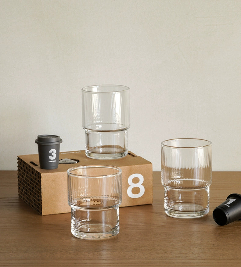 A set of Lyle Stackable Glasses, featuring sleek and minimalistic design. The glasses are crafted from high-quality, clear glass and are stackable for easy storage. Each glass holds 12 ounces, making them ideal for everyday use or entertaining. Perfect for home décor enthusiasts looking to add functional and stylish glassware to their kitchen or dining space.