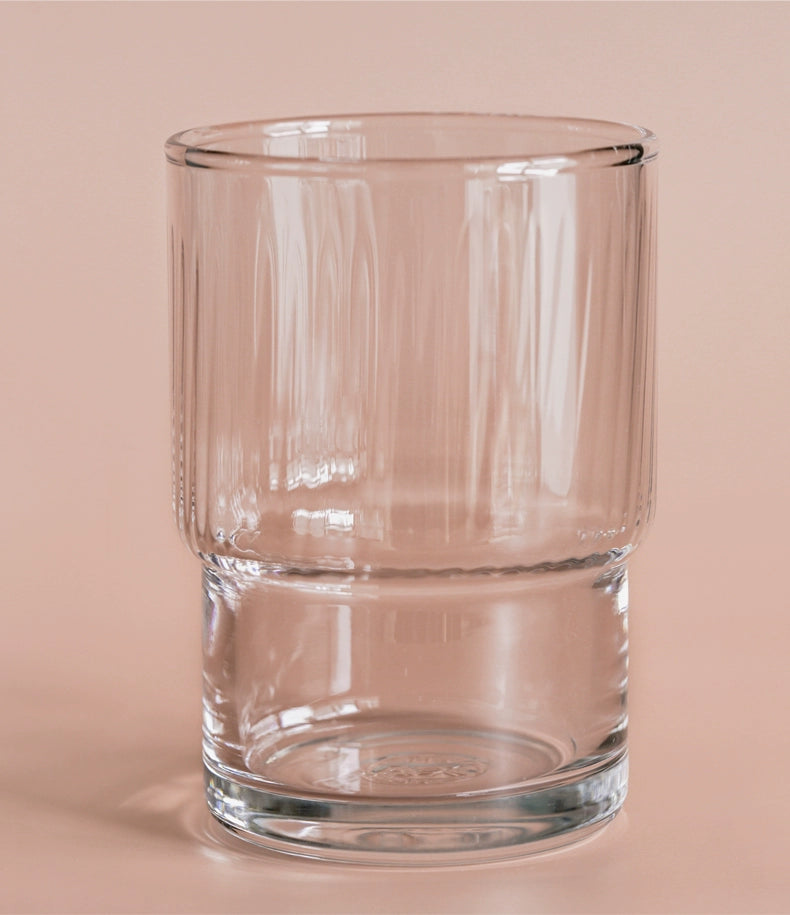 A set of Lyle Stackable Glasses, featuring sleek and minimalistic design. The glasses are crafted from high-quality, clear glass and are stackable for easy storage. Each glass holds 12 ounces, making them ideal for everyday use or entertaining. Perfect for home décor enthusiasts looking to add functional and stylish glassware to their kitchen or dining space.