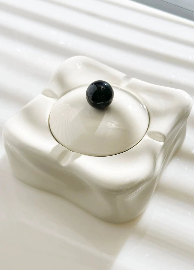 Foresta Ceramic Ashtray with cute ball detail, irregular shape, and modern design. Available in various colorways, choose between lidded or lidless options to suit your style. Crafted from high-quality ceramic for a sleek and contemporary smoking accessory.