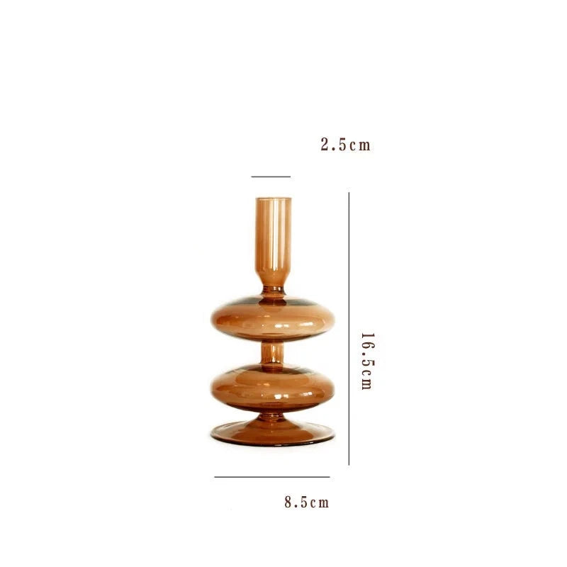 A brown glass Rhea Candle Holder set, featuring four different silhouettes in various sizes, creating a warm and inviting retro ambiance.