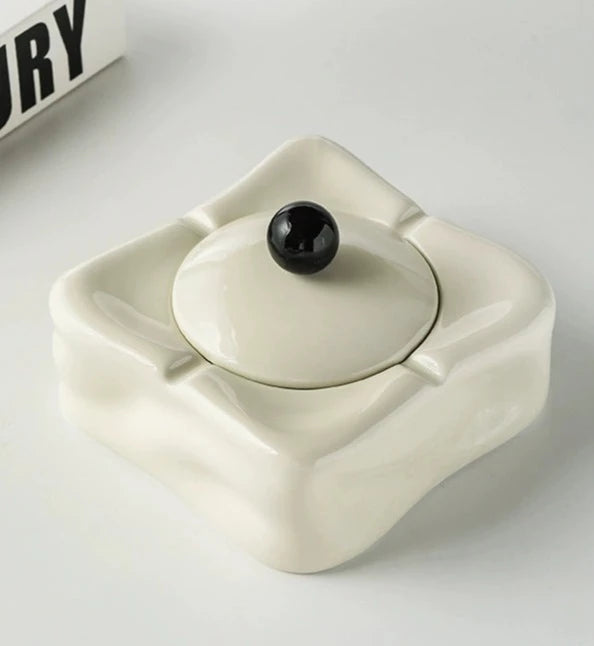 Foresta Ceramic Ashtray with cute ball detail, irregular shape, and modern design. Available in various colorways, choose between lidded or lidless options to suit your style. Crafted from high-quality ceramic for a sleek and contemporary smoking accessory.