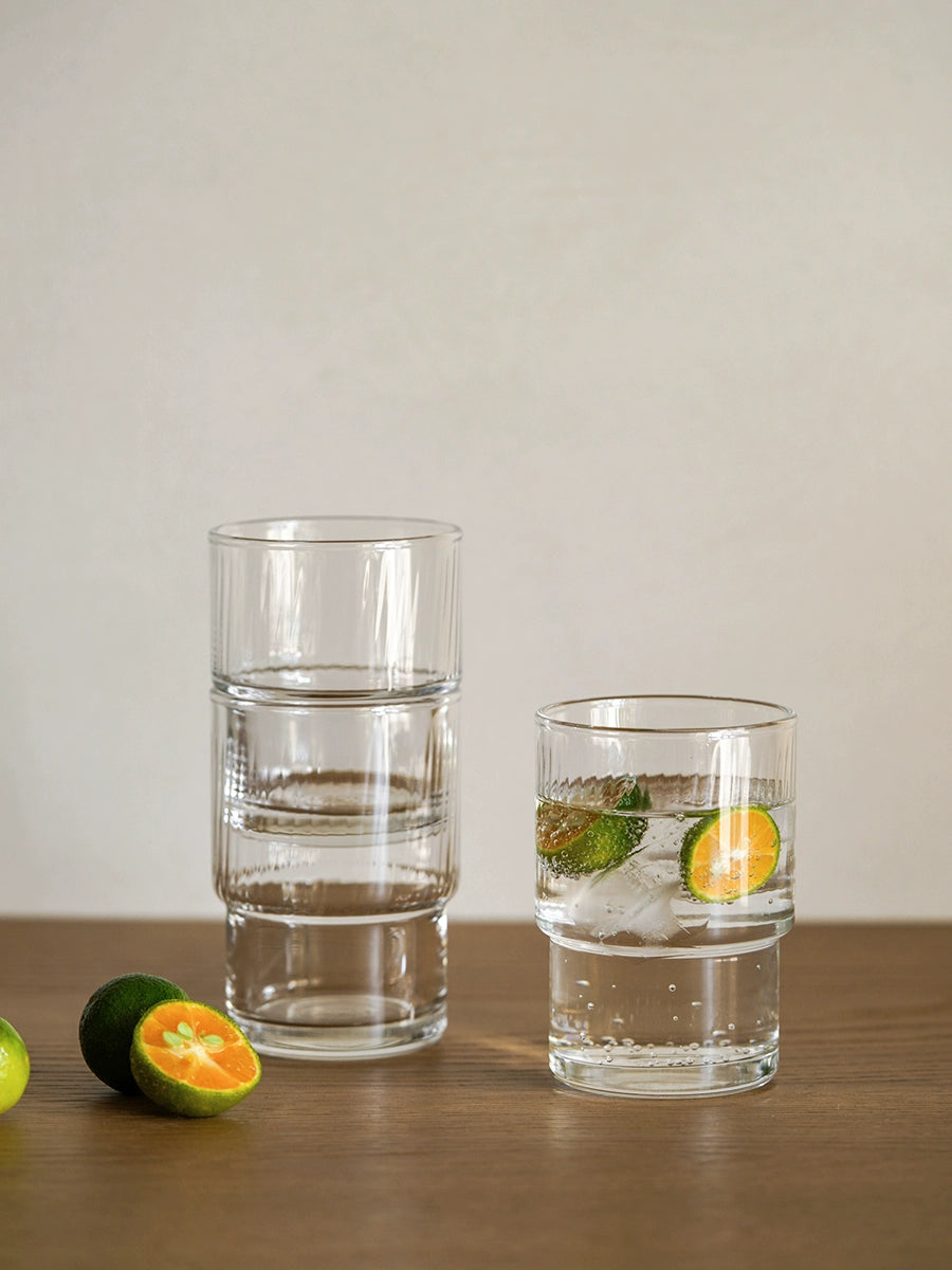 A set of Lyle Stackable Glasses, featuring sleek and minimalistic design. The glasses are crafted from high-quality, clear glass and are stackable for easy storage. Each glass holds 12 ounces, making them ideal for everyday use or entertaining. Perfect for home décor enthusiasts looking to add functional and stylish glassware to their kitchen or dining space.
