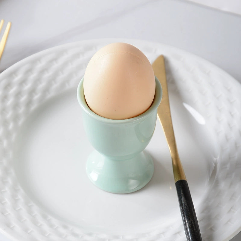 Stylish ceramic egg cup for drippy or hard-boiled eggs - vibrant colors, durable design. Perfect breakfast accessory.