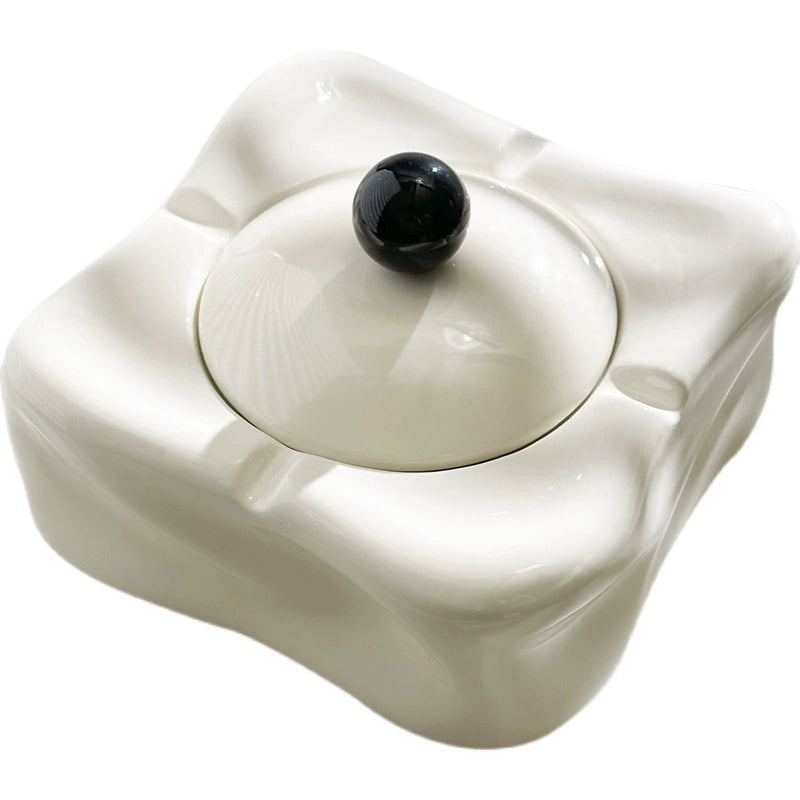 Foresta Ceramic Ashtray with cute ball detail, irregular shape, and modern design. Available in various colorways, choose between lidded or lidless options to suit your style. Crafted from high-quality ceramic for a sleek and contemporary smoking accessory.