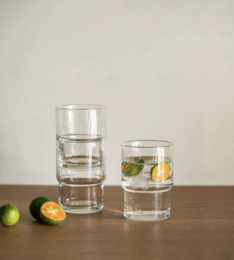 A set of Lyle Stackable Glasses, featuring sleek and minimalistic design. The glasses are crafted from high-quality, clear glass and are stackable for easy storage. Each glass holds 12 ounces, making them ideal for everyday use or entertaining. Perfect for home décor enthusiasts looking to add functional and stylish glassware to their kitchen or dining space.