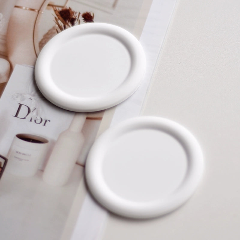 A collection of plaster trays from the Quinto Tray Collection, featuring various shapes and neutral colorways, suitable for use in different areas of the home.