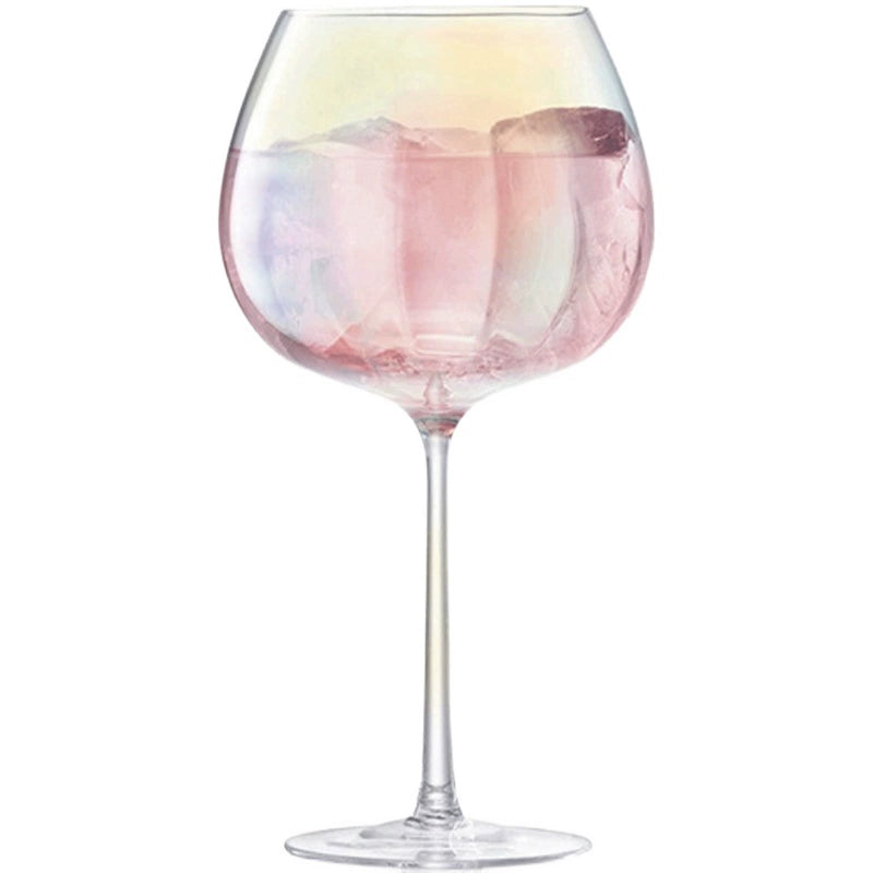 A collection of iridescent glassware from Domus Forge, featuring wine glasses, champagne coupes, decanters, and highball glasses in pastel gradient hues.