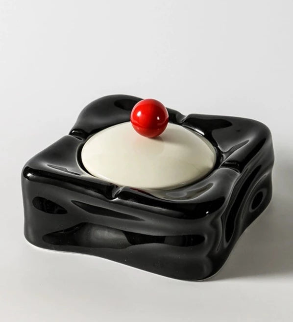 Foresta Ceramic Ashtray with cute ball detail, irregular shape, and modern design. Available in various colorways, choose between lidded or lidless options to suit your style. Crafted from high-quality ceramic for a sleek and contemporary smoking accessory.