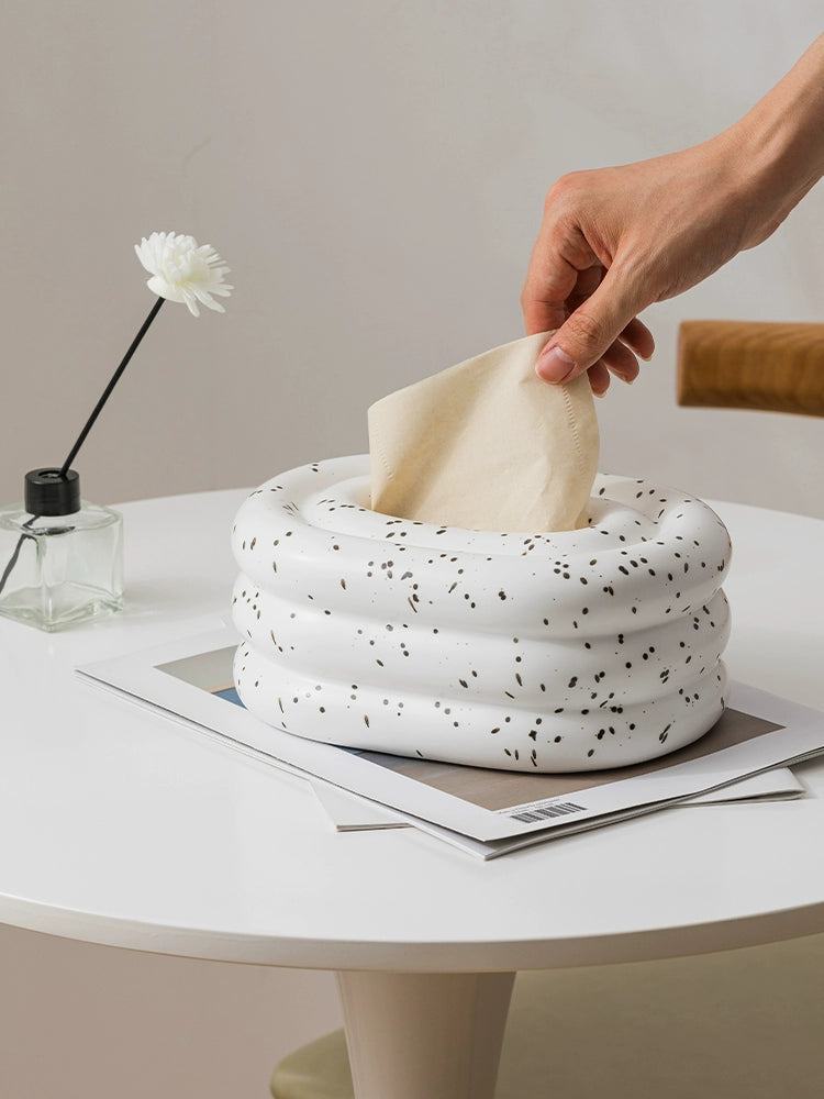 A modern ceramic tissue box cover with an oval shape, available in various stylish colorways. The cover adds a touch of contemporary elegance to home decor, seamlessly concealing tissue boxes while maintaining functional and chic design.