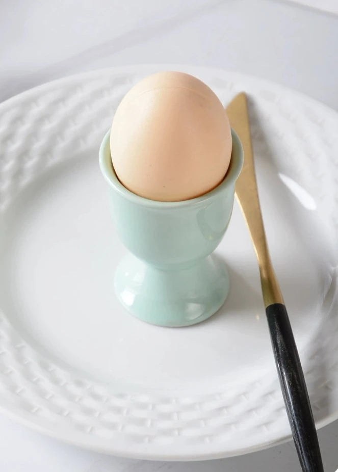 Stylish ceramic egg cup for drippy or hard-boiled eggs - vibrant colors, durable design. Perfect breakfast accessory.