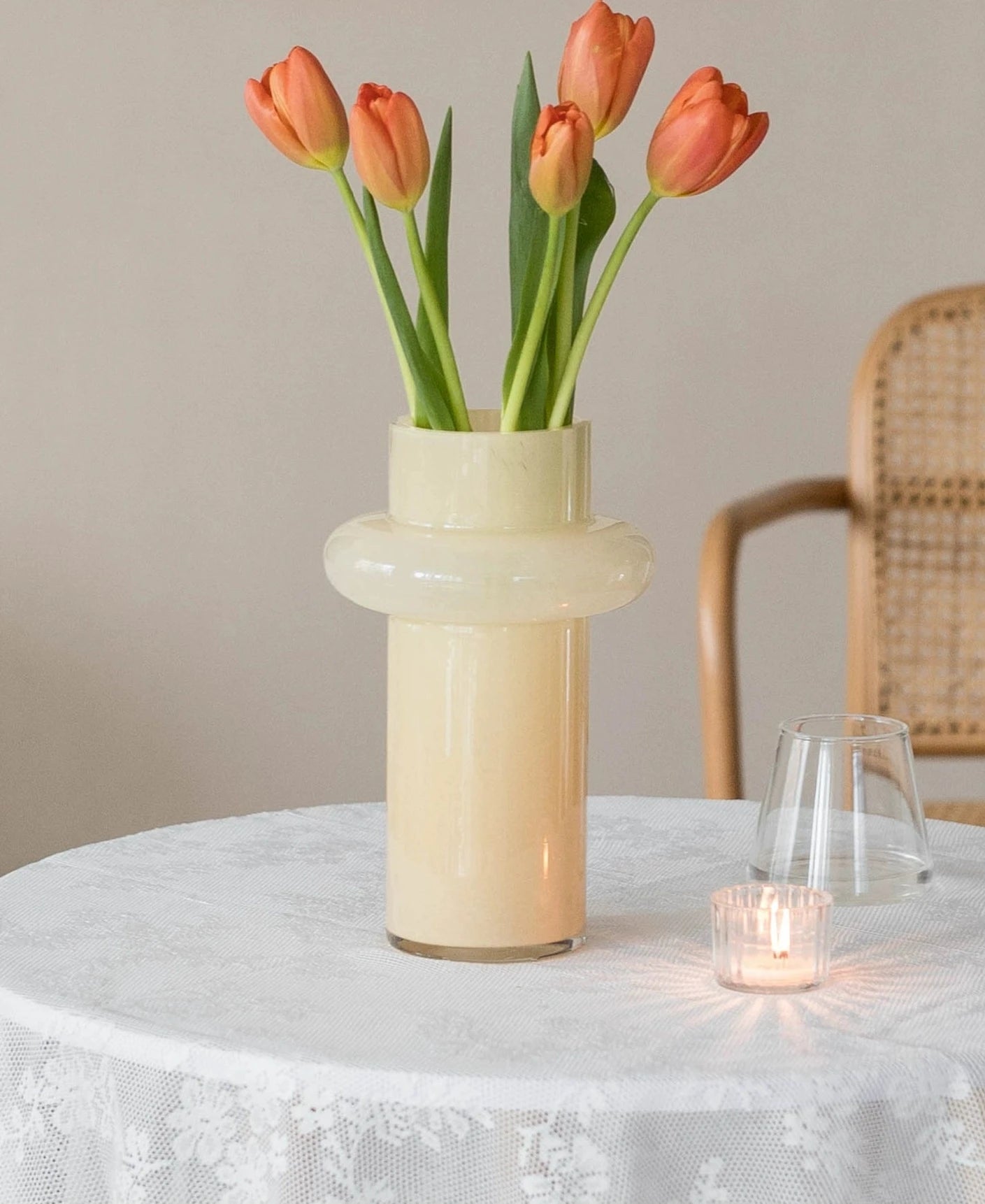 Modern glass vase in cream, ideal for home décor.