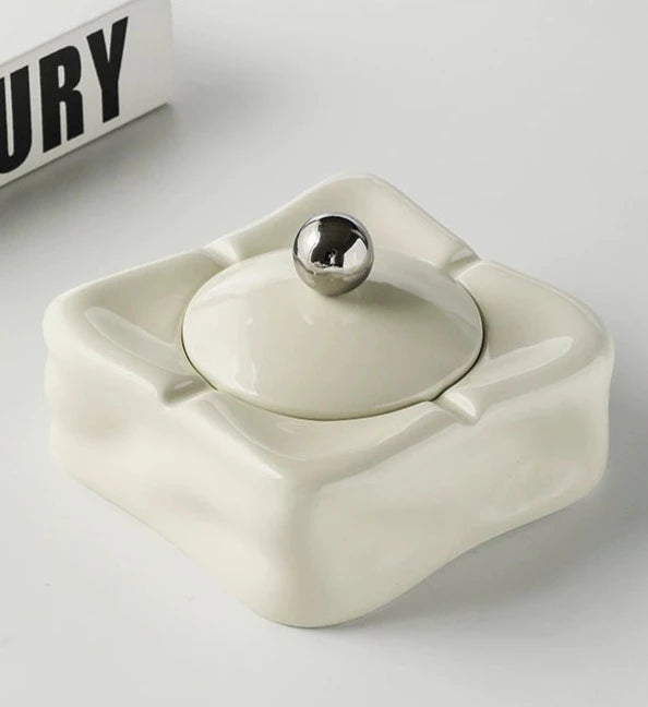 Foresta Ceramic Ashtray with cute ball detail, irregular shape, and modern design. Available in various colorways, choose between lidded or lidless options to suit your style. Crafted from high-quality ceramic for a sleek and contemporary smoking accessory.
