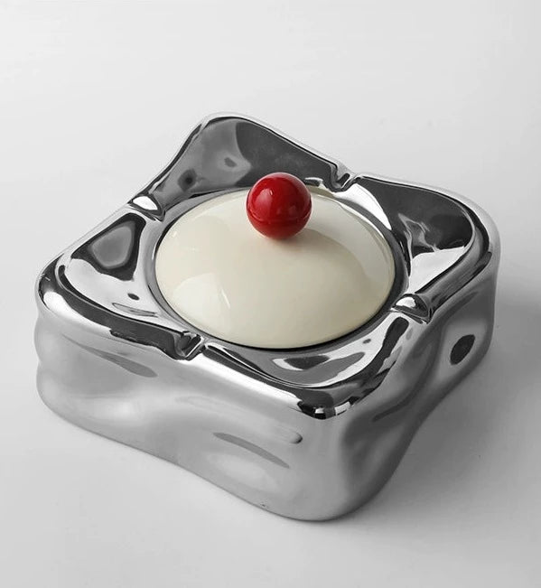 Foresta Ceramic Ashtray with cute ball detail, irregular shape, and modern design. Available in various colorways, choose between lidded or lidless options to suit your style. Crafted from high-quality ceramic for a sleek and contemporary smoking accessory.
