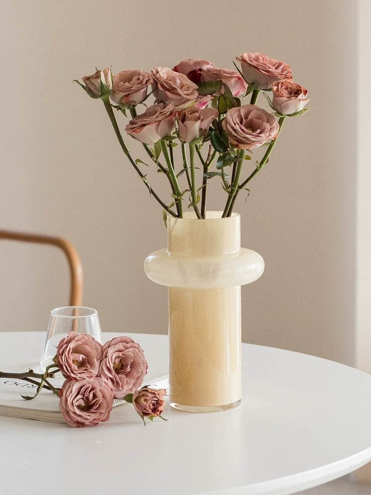 Modern glass vase in cream, ideal for home décor.