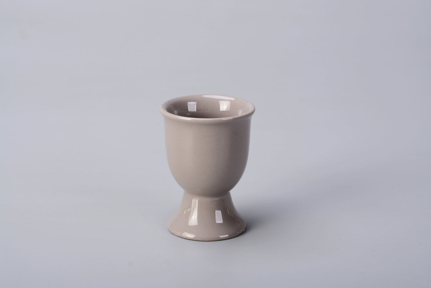 Stylish ceramic egg cup for drippy or hard-boiled eggs - vibrant colors, durable design. Perfect breakfast accessory.