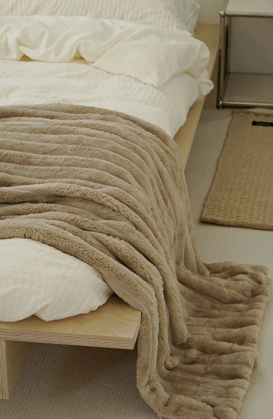 Veer Throw Blanket - Embrace ultimate comfort with this cozy double-sided blanket crafted from fuzzy coral velvet. Its minimalist design in neutral colors seamlessly blends with any decor. Available in three sizes for the perfect fit. Indulge in warmth and style with the Veer Blanket.