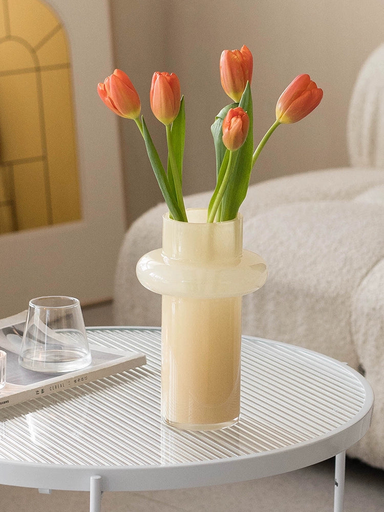 Modern glass vase in cream, ideal for home décor.