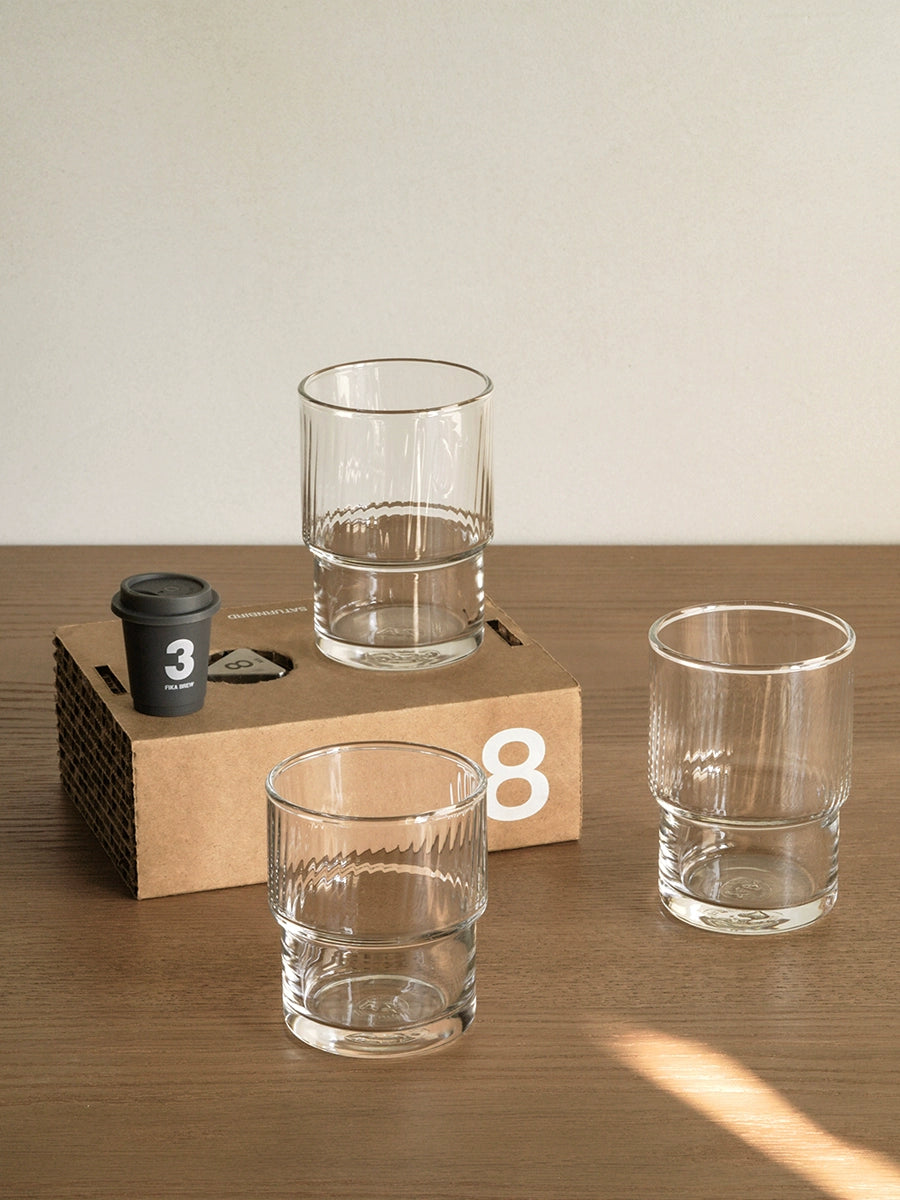 A set of Lyle Stackable Glasses, featuring sleek and minimalistic design. The glasses are crafted from high-quality, clear glass and are stackable for easy storage. Each glass holds 12 ounces, making them ideal for everyday use or entertaining. Perfect for home décor enthusiasts looking to add functional and stylish glassware to their kitchen or dining space.