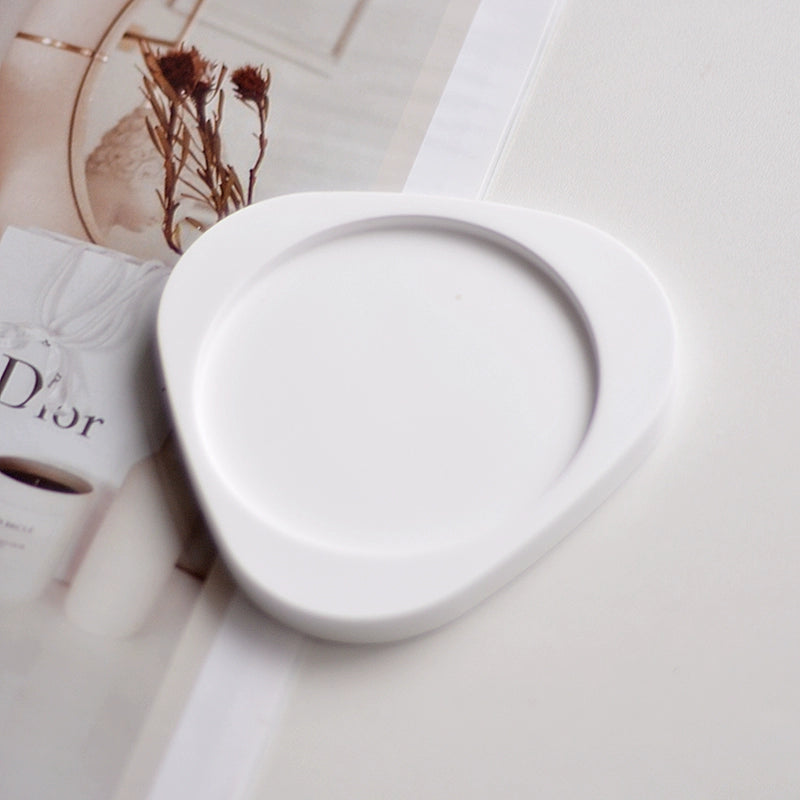 A collection of plaster trays from the Quinto Tray Collection, featuring various shapes and neutral colorways, suitable for use in different areas of the home.