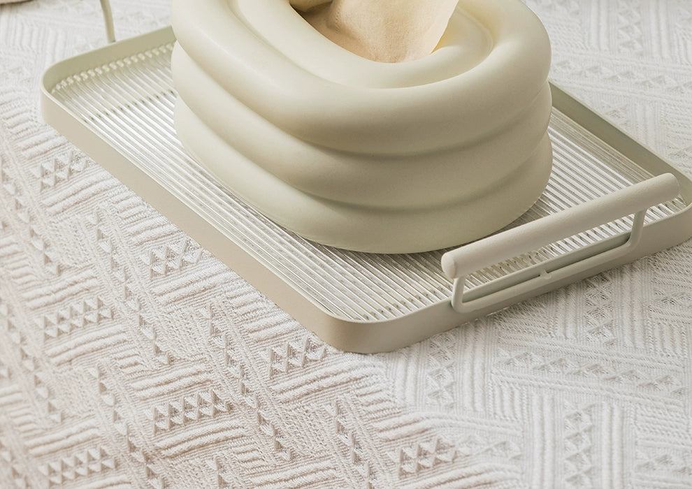 A modern ceramic tissue box cover with an oval shape, available in various stylish colorways. The cover adds a touch of contemporary elegance to home decor, seamlessly concealing tissue boxes while maintaining functional and chic design.