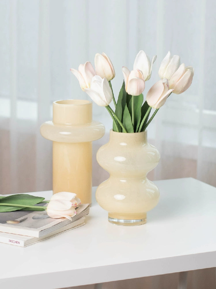 Modern glass vase in cream, ideal for home décor.