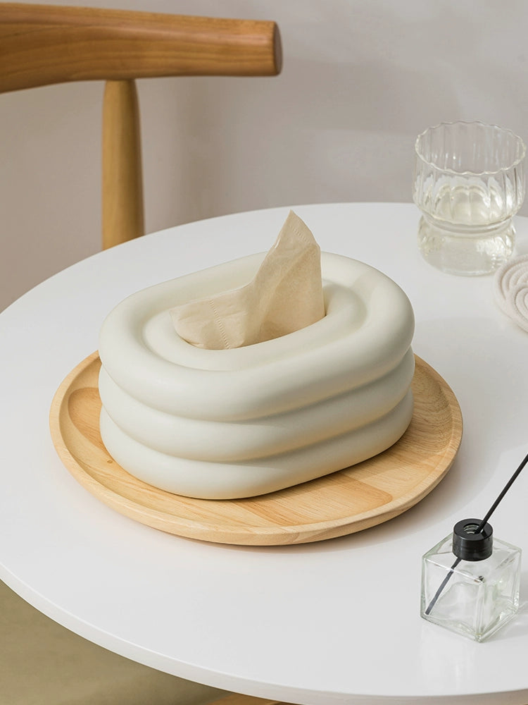A modern ceramic tissue box cover with an oval shape, available in various stylish colorways. The cover adds a touch of contemporary elegance to home decor, seamlessly concealing tissue boxes while maintaining functional and chic design.