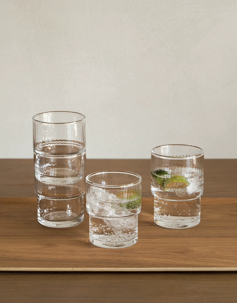 A set of Lyle Stackable Glasses, featuring sleek and minimalistic design. The glasses are crafted from high-quality, clear glass and are stackable for easy storage. Each glass holds 12 ounces, making them ideal for everyday use or entertaining. Perfect for home décor enthusiasts looking to add functional and stylish glassware to their kitchen or dining space.