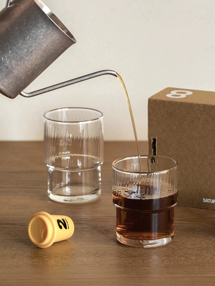 A set of Lyle Stackable Glasses, featuring sleek and minimalistic design. The glasses are crafted from high-quality, clear glass and are stackable for easy storage. Each glass holds 12 ounces, making them ideal for everyday use or entertaining. Perfect for home décor enthusiasts looking to add functional and stylish glassware to their kitchen or dining space.