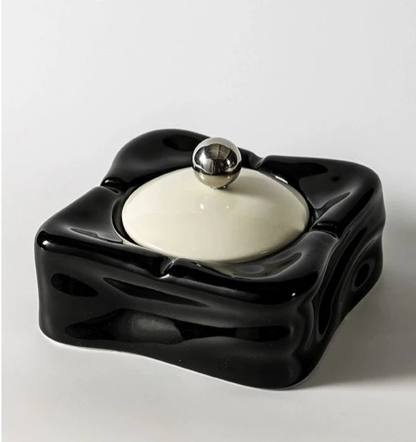 Foresta Ceramic Ashtray with cute ball detail, irregular shape, and modern design. Available in various colorways, choose between lidded or lidless options to suit your style. Crafted from high-quality ceramic for a sleek and contemporary smoking accessory.