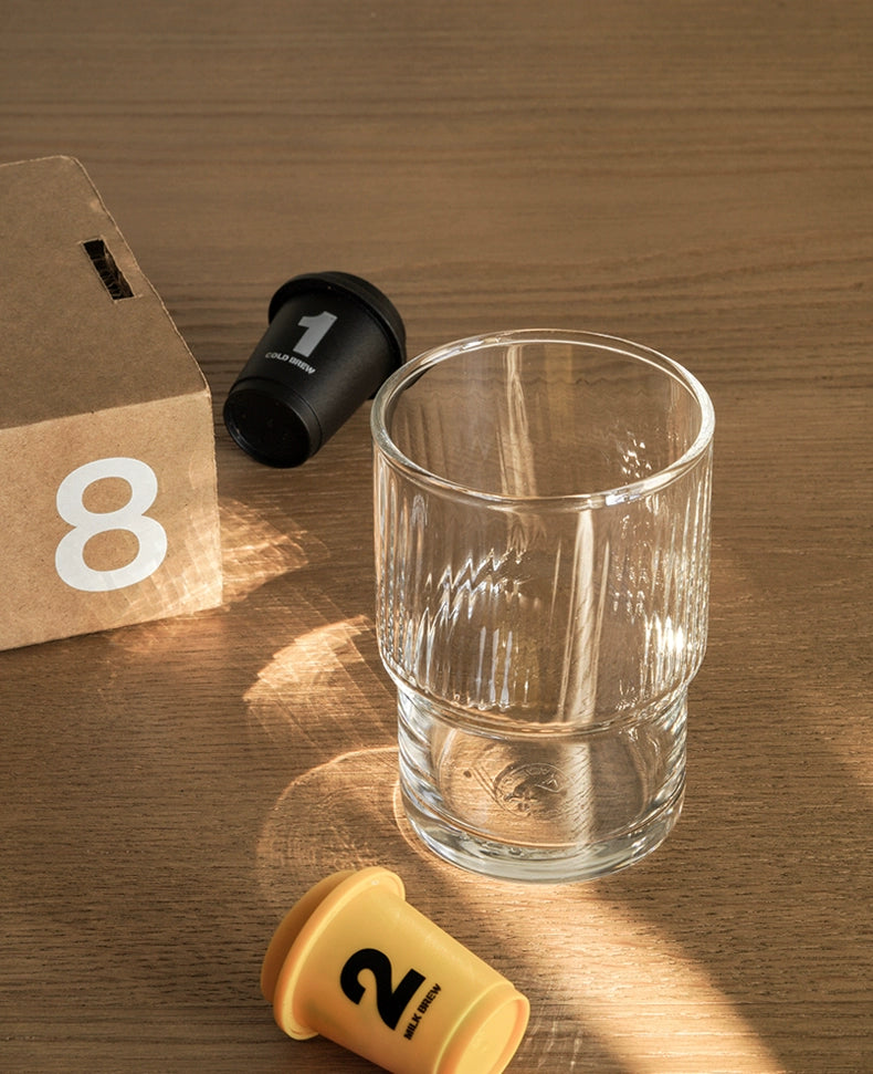A set of Lyle Stackable Glasses, featuring sleek and minimalistic design. The glasses are crafted from high-quality, clear glass and are stackable for easy storage. Each glass holds 12 ounces, making them ideal for everyday use or entertaining. Perfect for home décor enthusiasts looking to add functional and stylish glassware to their kitchen or dining space.