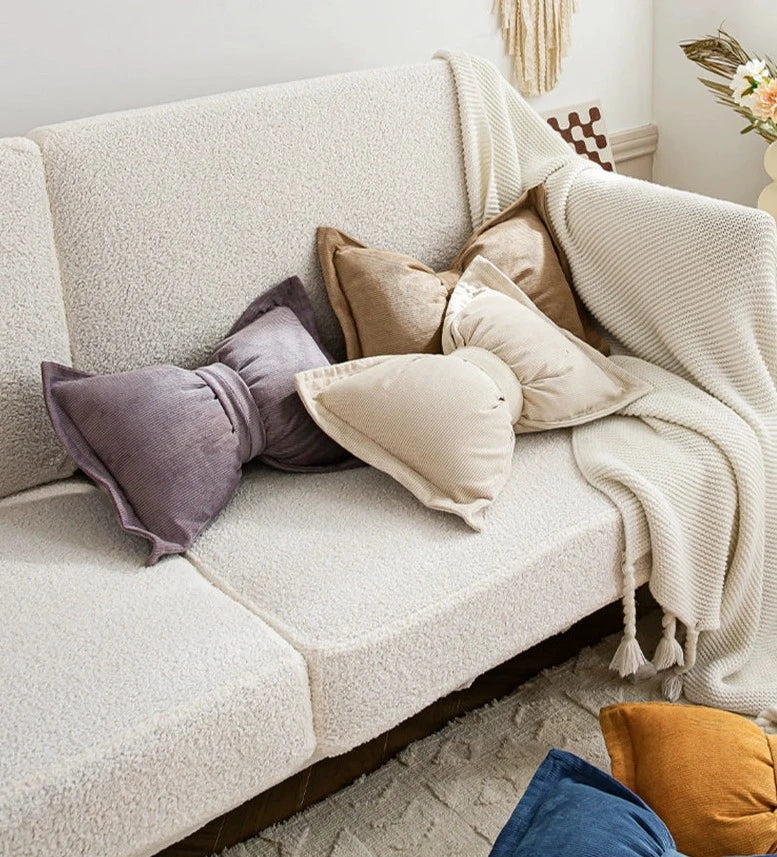 Soft corduroy bow-shaped throw pillow in various colors - perfect living room or bedroom accent.