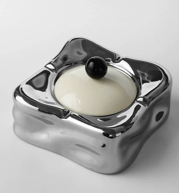 Foresta Ceramic Ashtray with cute ball detail, irregular shape, and modern design. Available in various colorways, choose between lidded or lidless options to suit your style. Crafted from high-quality ceramic for a sleek and contemporary smoking accessory.
