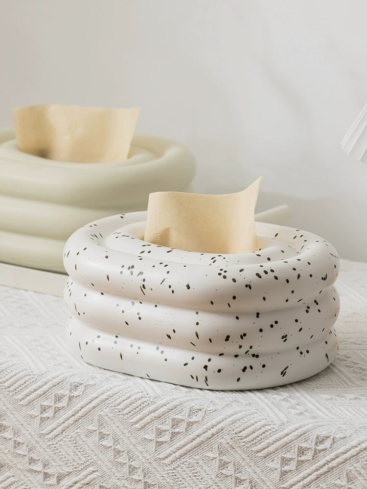 A modern ceramic tissue box cover with an oval shape, available in various stylish colorways. The cover adds a touch of contemporary elegance to home decor, seamlessly concealing tissue boxes while maintaining functional and chic design.