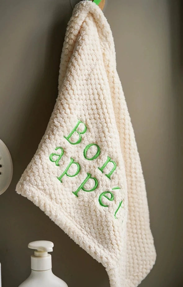 Charming Tal Kitchen Towels in four colorways with French texts embroidery, featuring a convenient hang loop. Soft and absorbent cotton for a delightful and efficient kitchen experience.