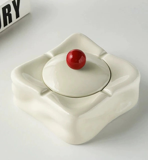 Foresta Ceramic Ashtray with cute ball detail, irregular shape, and modern design. Available in various colorways, choose between lidded or lidless options to suit your style. Crafted from high-quality ceramic for a sleek and contemporary smoking accessory.