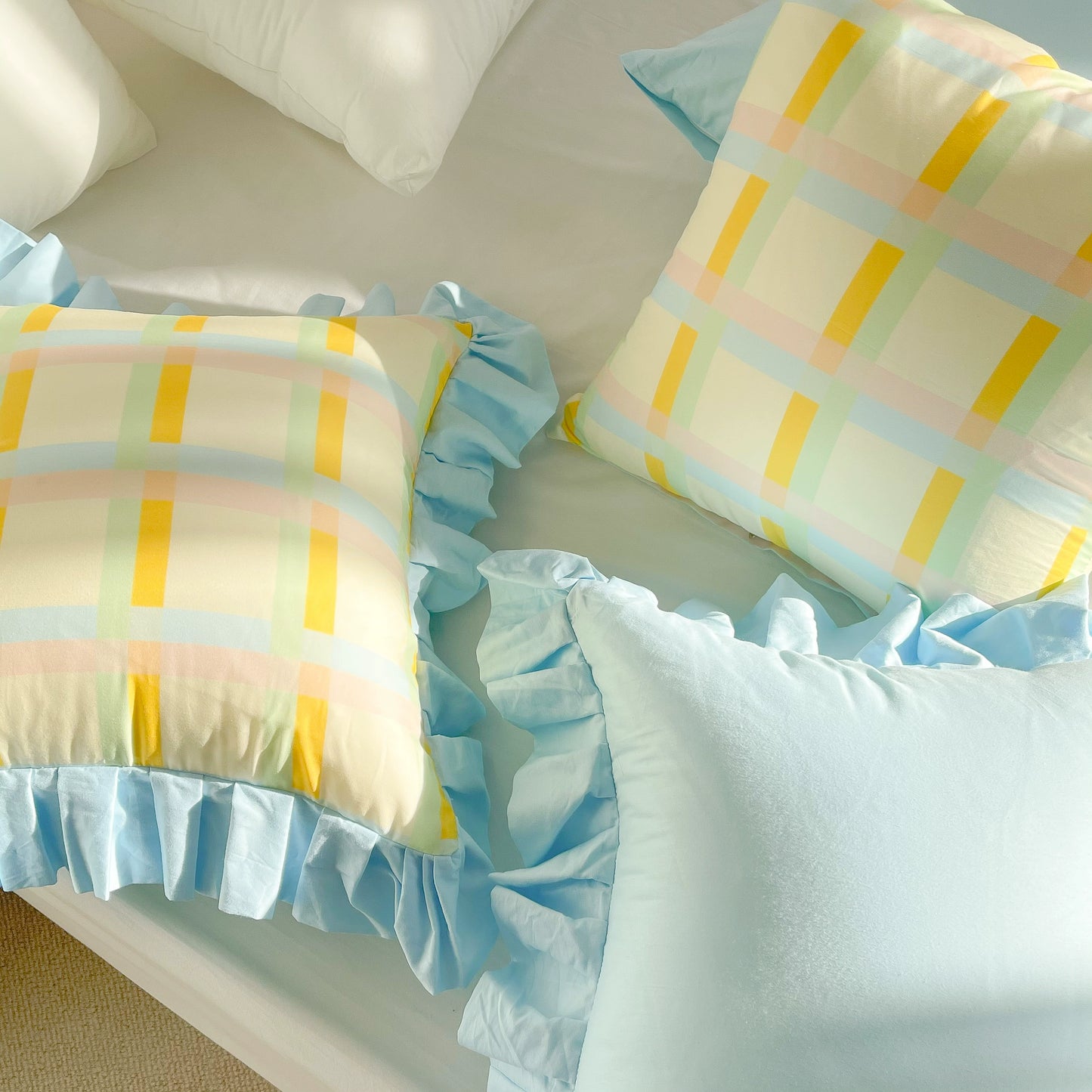 Vibrant cotton throw pillows with ruffle detail, available in solid or lattice prints