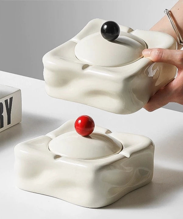 Foresta Ceramic Ashtray with cute ball detail, irregular shape, and modern design. Available in various colorways, choose between lidded or lidless options to suit your style. Crafted from high-quality ceramic for a sleek and contemporary smoking accessory.