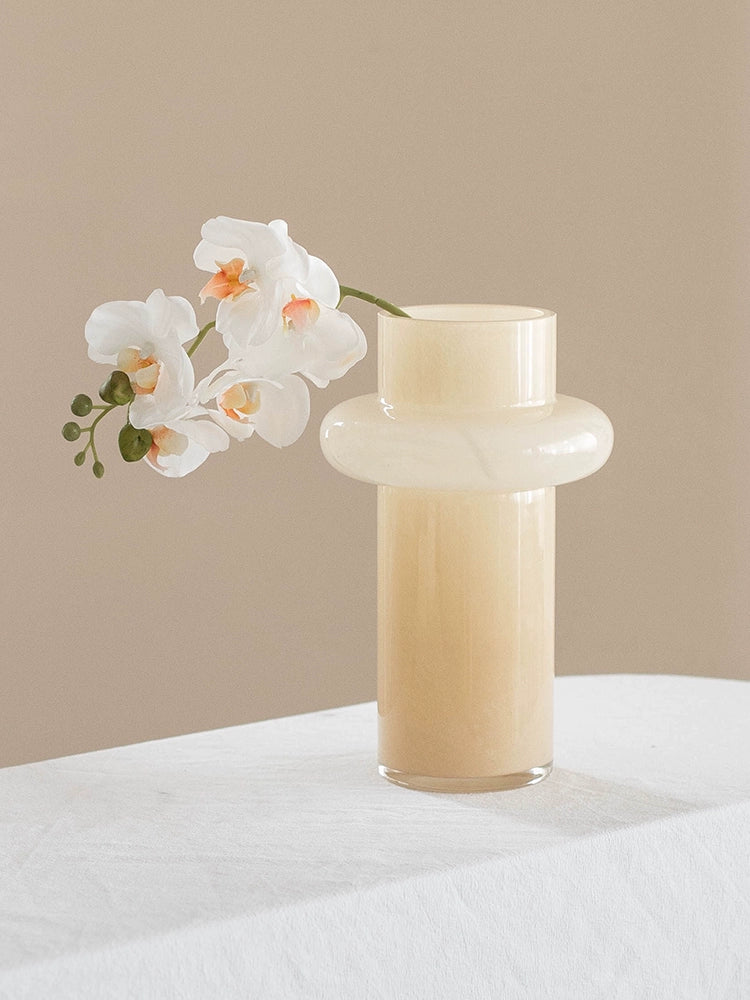 Modern glass vase in cream, ideal for home décor.