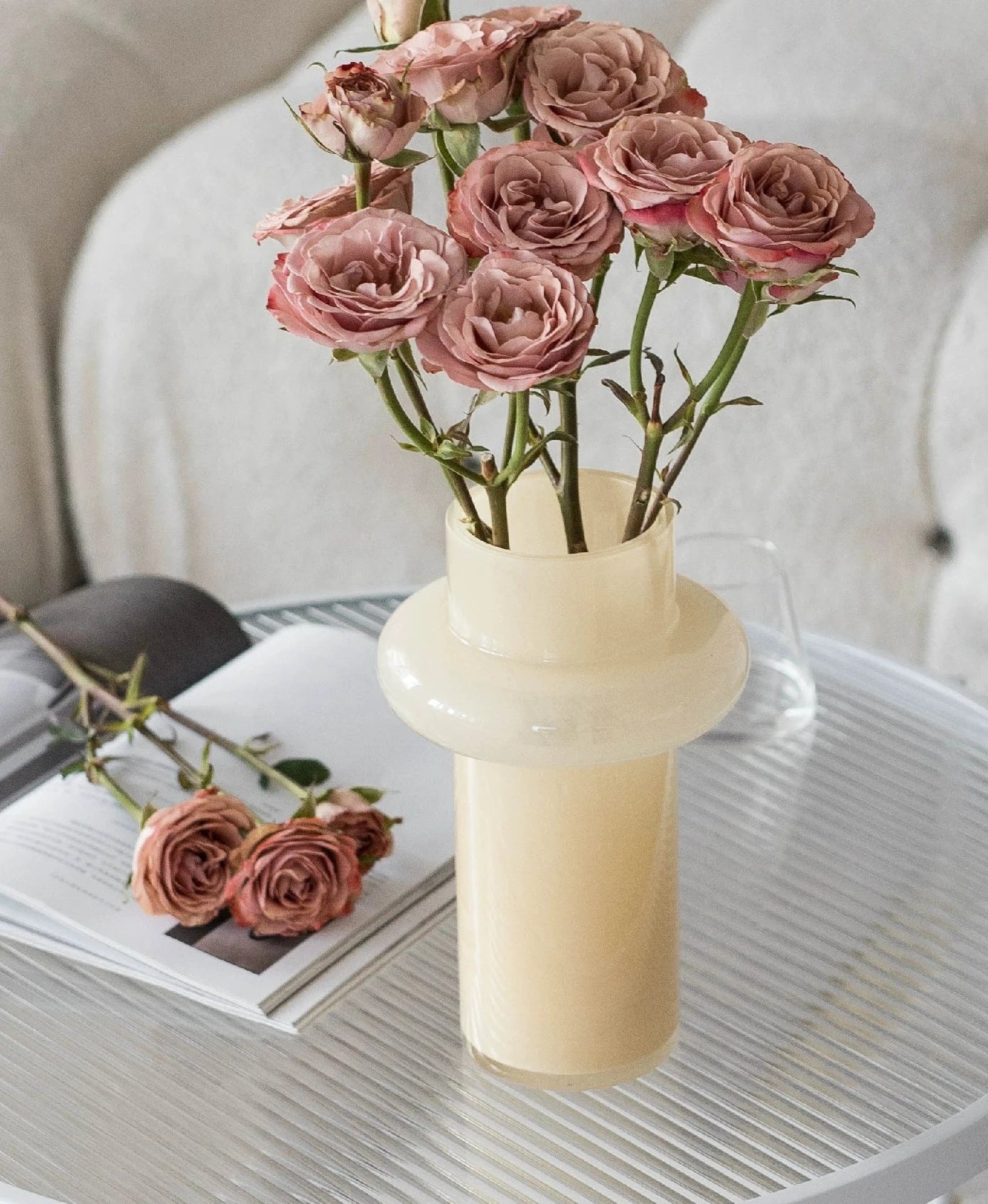 Modern glass vase in cream, ideal for home décor.